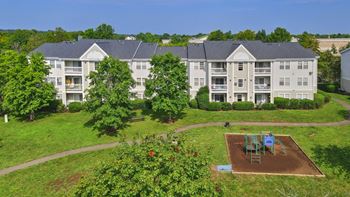 Playground area with apartment buildings and landscaping